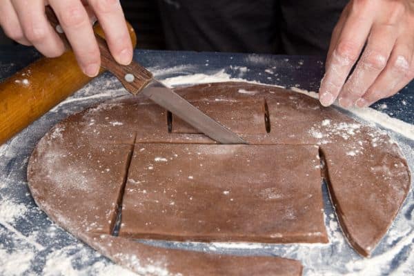 cutting out pieces for gluten-free gingerbread house