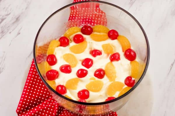 adding fruit to a eggnog trifle dessert