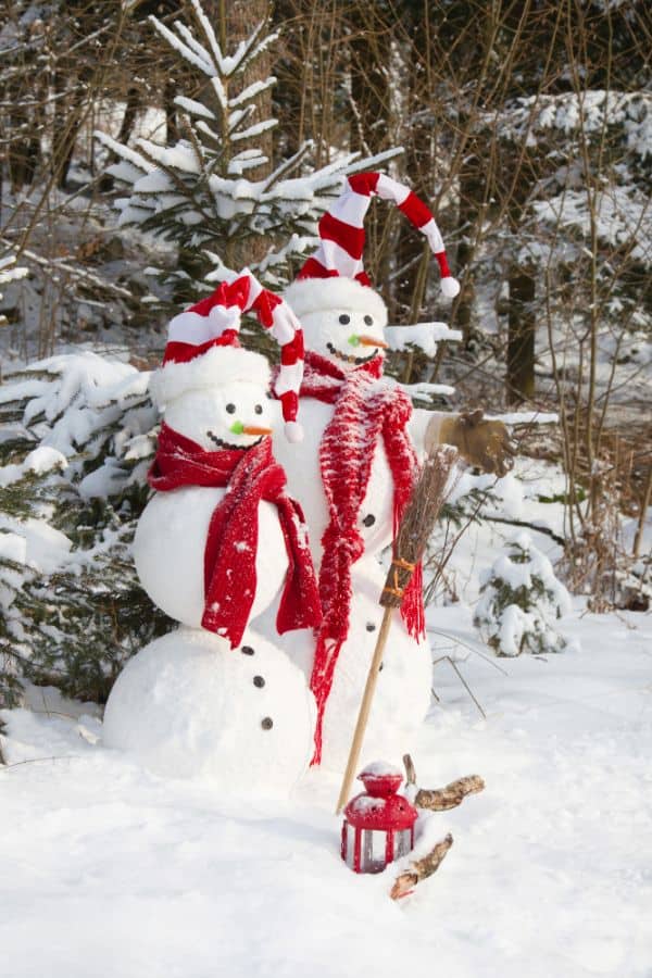 2 snowmen with tall red and white hats and red scarves