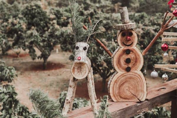 snowman made from wood slices and sticks