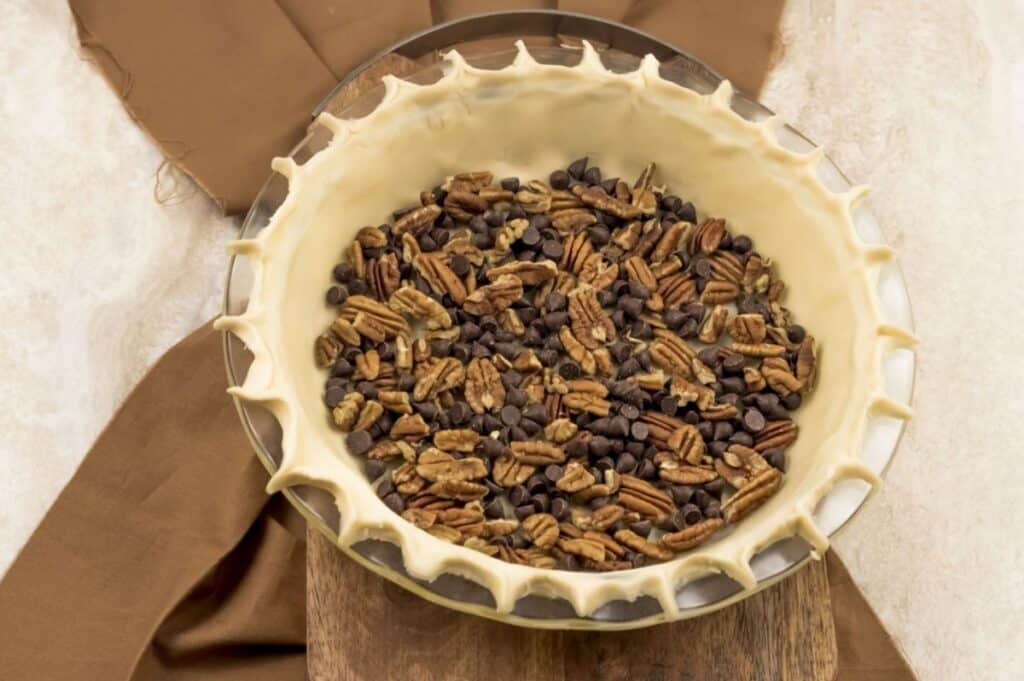 pie crust with chocolate chips and pecan base