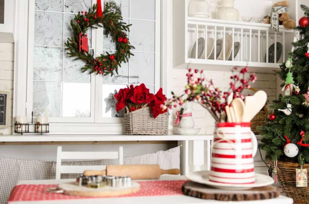 kitchen decorated for Christmas with wreath and red and white decor
