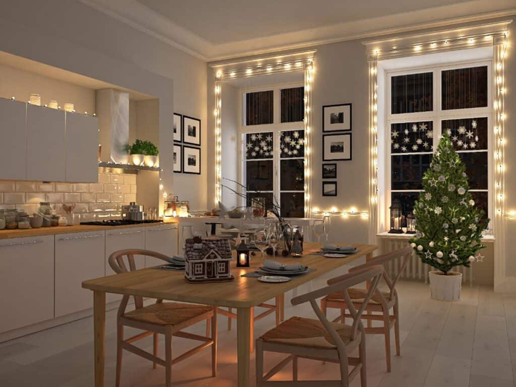 simple elegant kitchen decorated for Christmas with white lights and small tree