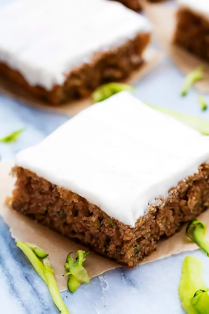 Slice of zucchini cake with white frosting