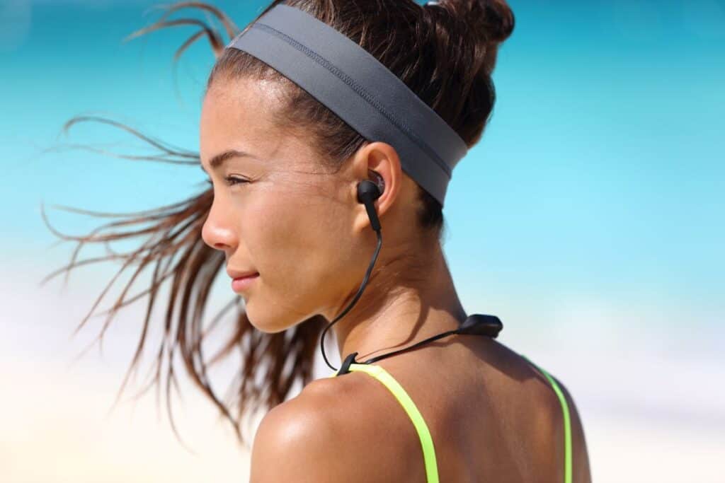 woman wearing headband and earbuds