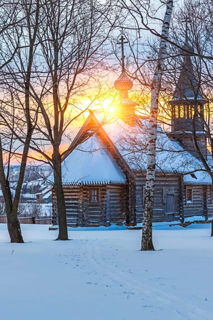 wooden church with snow on the ground