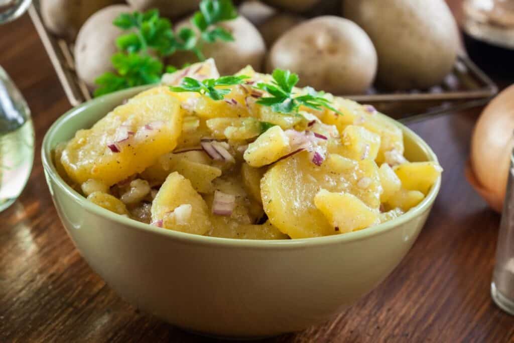 German potato salad in a light green bowl