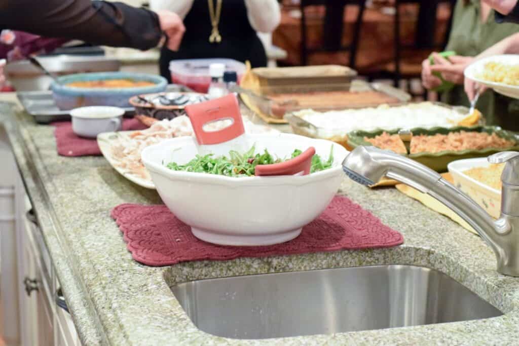 table with a variety of prepared foods in containers