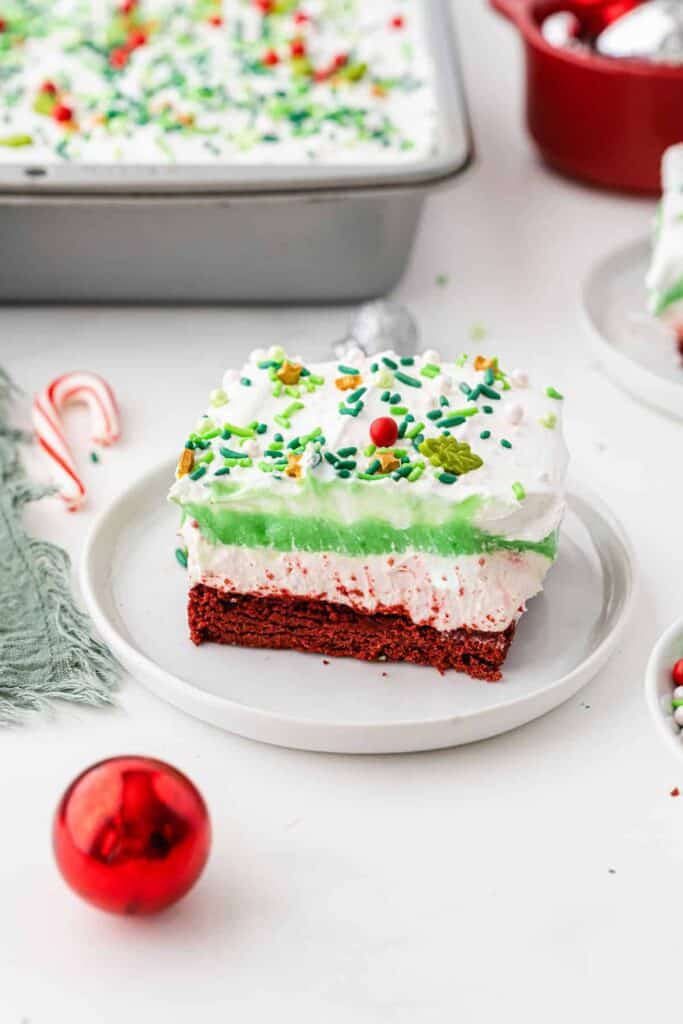 Slice of green, red and white lasagna cake on a plate