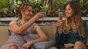 Emily and her friend share a toast in PERFECT MESSY HOLIDAY