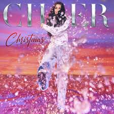 A Cher Christmas cover of a woman in a white shirt and jeans playing in water.