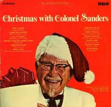 Colonel Sanders wearing a santa hat